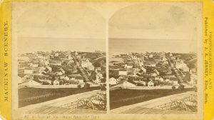 Stereoview, ca. 1870. The original Mackinac Hotel is the fifth building from the corner on the land side of Main Street.