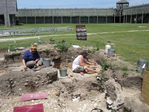 Janie is excavating 1781 demolition rubble and the mystery trench is behind John.
