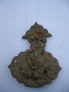 an intact lock from a small chest or similar item of furniture. It is made of brass, 2.75” long and 2.25” wide at its widest point.