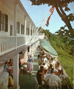 Patrons enjoying lunch with a view, ca. 1965. Note the colonial-style uniforms worn by the waitresses. 