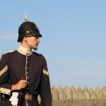 A soldier at Fort Mackinac holding a rifle.