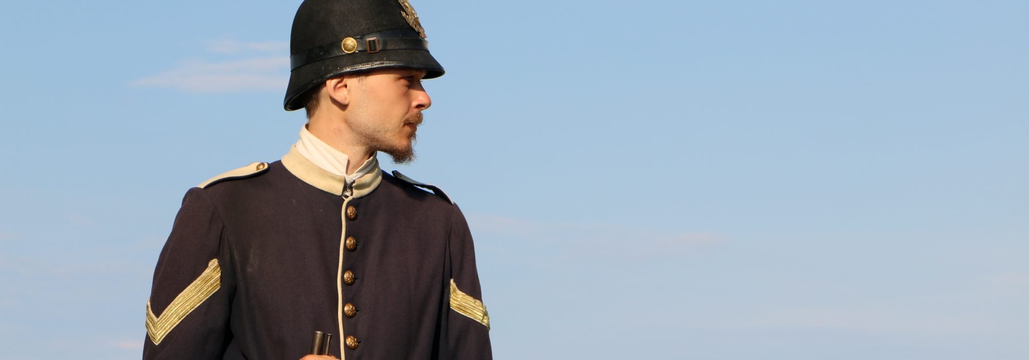 A soldier at Fort Mackinac holding a rifle.