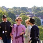 Costumed interpreters portraying 1880s soldiers and Victorian women at Fort Mackinac.