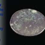 A photo of a British halfpenny recovered during an archaeological dig at Colonial Michilimackinac