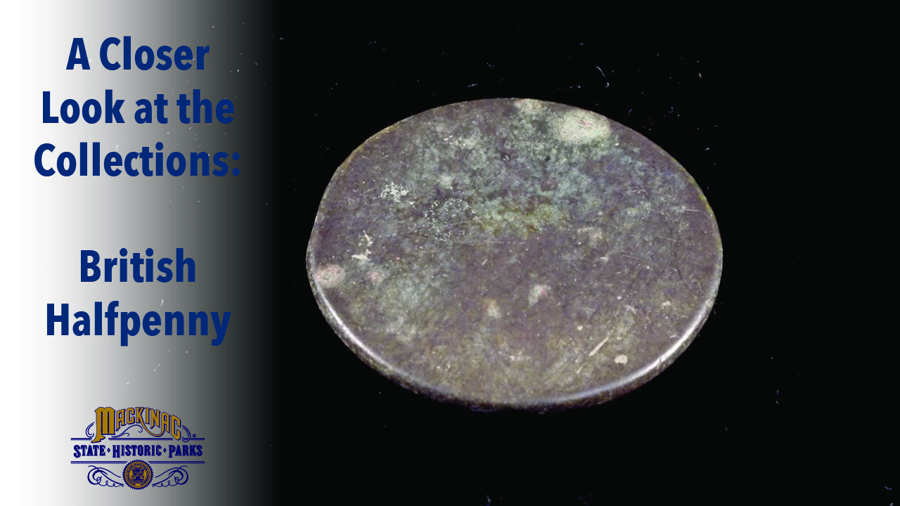 A photo of a British halfpenny recovered during an archaeological dig at Colonial Michilimackinac