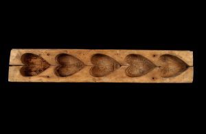 A wooden maple sugar mold. 