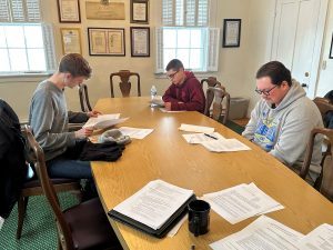 Fort Mackinac staff working in an office space learning about the fort and its history. 