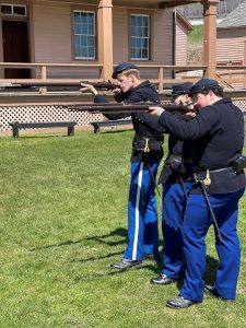 Historic Interpreters at Fort Mackinac preparing to fire rifles. 