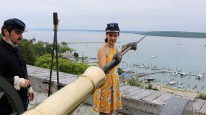 A guest helping to fire the Fort Mackinac cannon. 