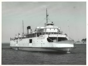 The City of Cheboygan Auto Ferry on the water. 