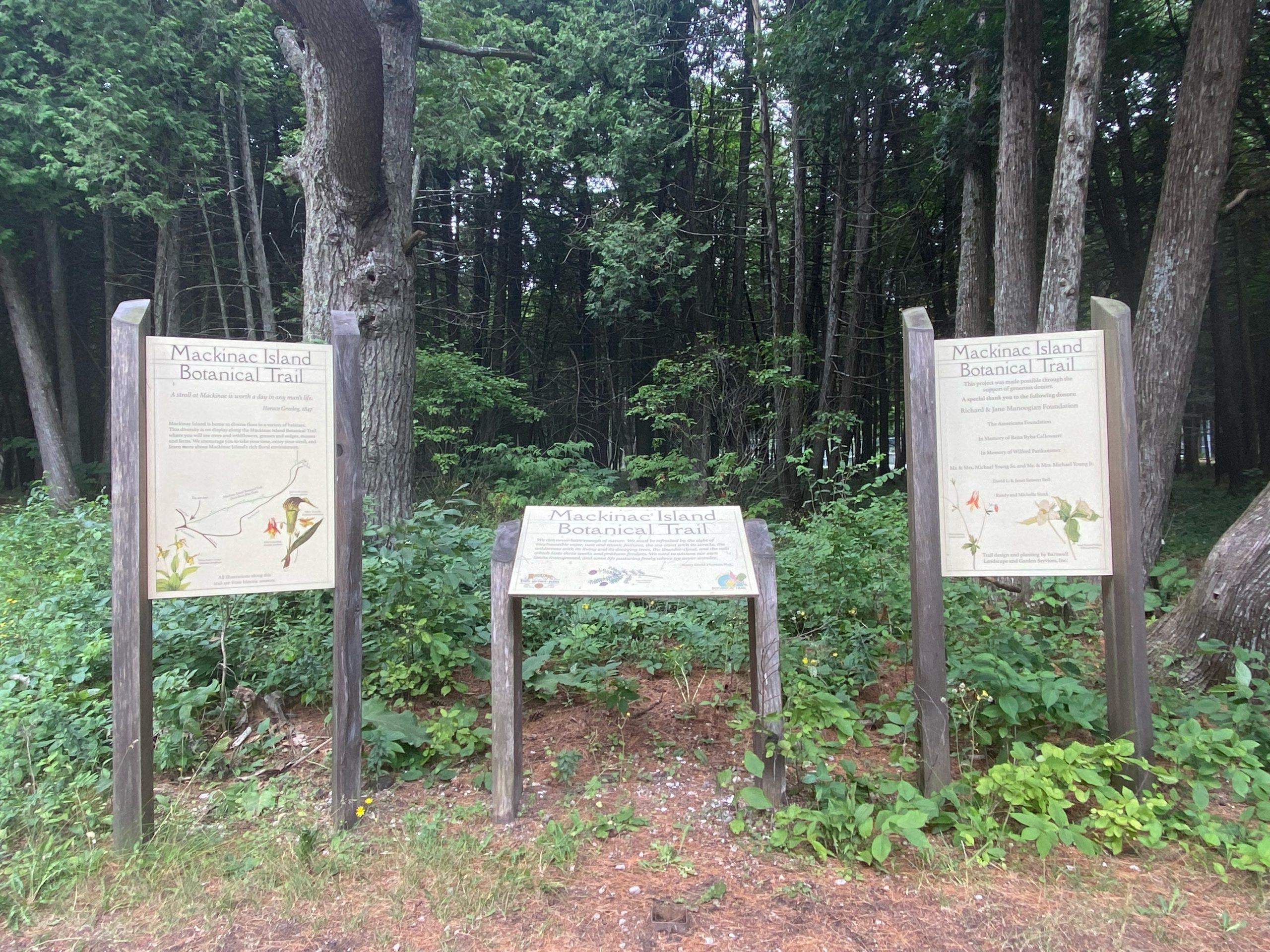 Three signs on the Mackinac Island Botanical Trail.