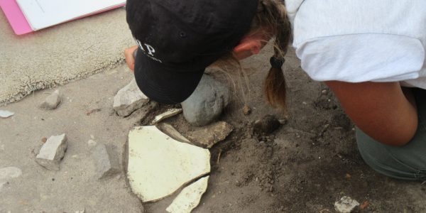 Archaeology Supervisor Alex Connel excavating the creamware plate.
