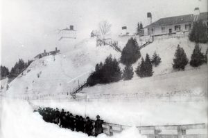 Fort Mackinac soldiers clearing a path in front of Fort Mackinac in the 1880s.
