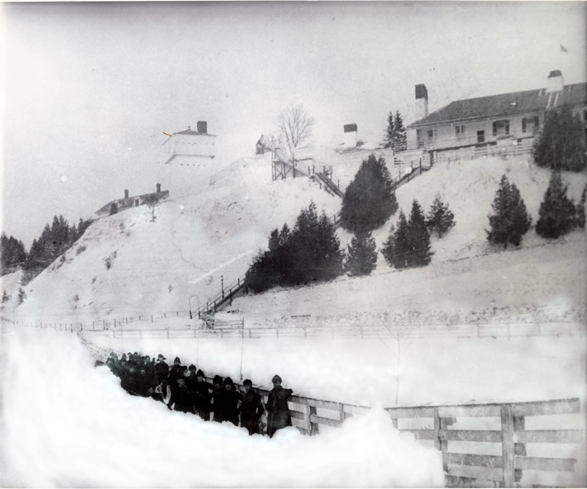 Fort Mackinac soldiers clearing a path in front of Fort Mackinac in the 1880s.