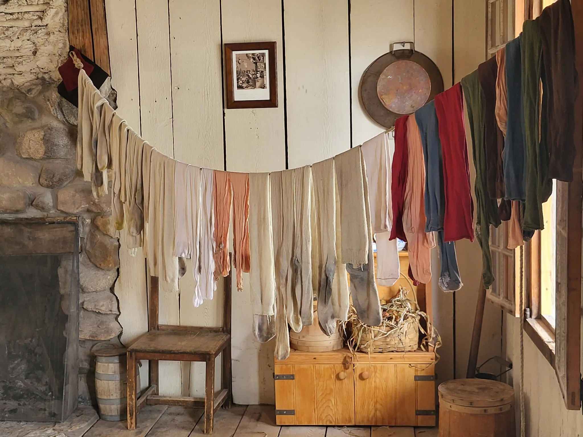 Socks hung on a line inside a building at Michilimackinac.